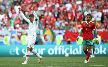 Soccer Football - World Cup - Group B - Portugal vs Morocco - Luzhniki Stadium, Moscow, Russia - June 20, 2018 Portugal's Cristiano Ronaldo celebrates as Morocco's Manuel da Costa looks dejected after the match REUTERS/Carl Recine