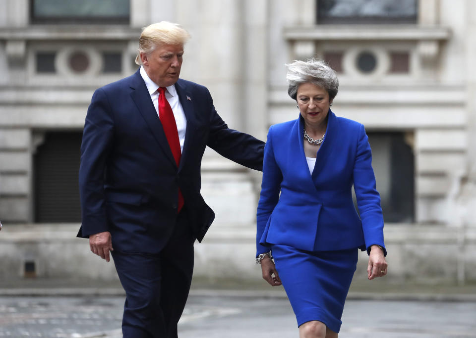 <p> Britain's Prime Minister Theresa May and President Donald Trump walk through the Quadrangle of the Foreign Office for a joint press conference in central London, Tuesday, June 4, 2019. (AP Photo/Frank Augstein) </p>