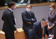 Dutch Prime Minister Mark Rutte, left, speaks with Luxembourg's Prime Minister Xavier Bettel, center, and Estonia's Prime Minister Kaja Kallas, right, during a round table meeting at an EU summit in Brussels, Friday, Oct. 22, 2021. European Union leaders conclude a two-day summit on Friday in which they discussed issues such as climate change, the energy crisis, COVID-19 developments and migration.(AP Photo/Olivier Matthys, Pool)