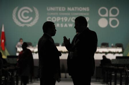 Delegates talk during a break in a plenary session on the second day of the 19th conference of the United Nations Framework Convention on Climate Change (COP19) at the National Stadium in Warsaw November 12, 2013. REUTERS/Kacper Pempel