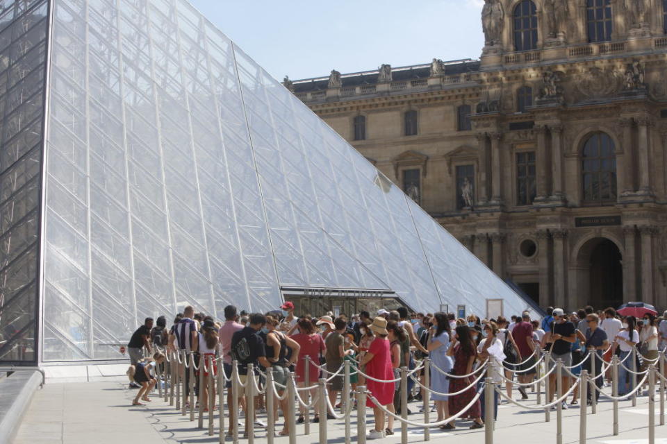 Tourists waiting in line in front the Louvre Museum on Monday (local time).