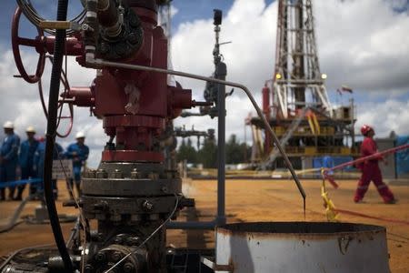 Crude oil drips from a valve at an oil well operated by Venezuela's state oil company PDVSA in Morichal July 28, 2011.REUTERS/Carlos Garcia Rawlins