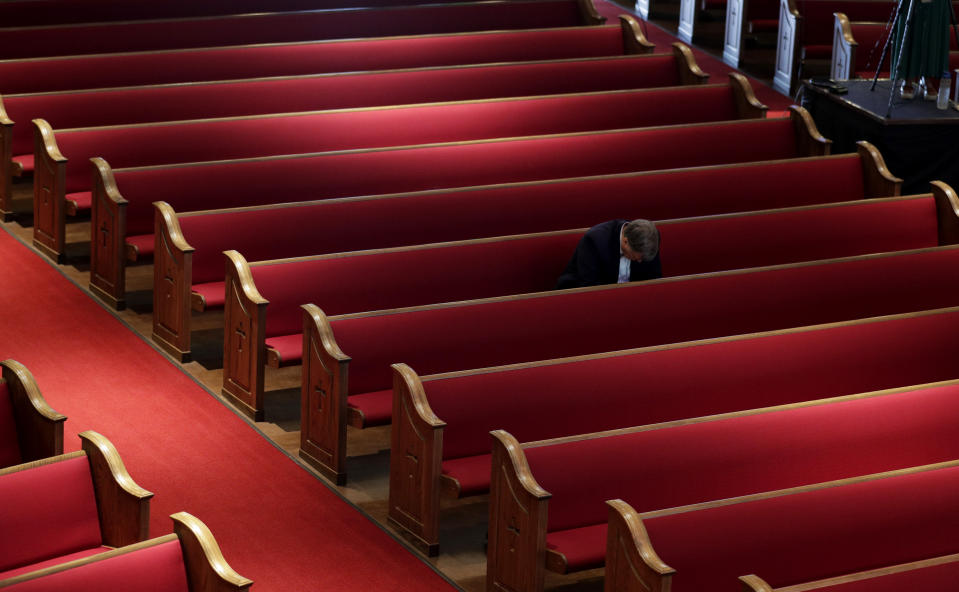 A man prays while attending an Easter service at Trinity Baptist Church in San Antonio, Sunday, April 12, 2020. Many churches are adapting their services as Christians around the world are celebrating Easter at a distance due to the COVID-19 pandemic. (AP Photo/Eric Gay)