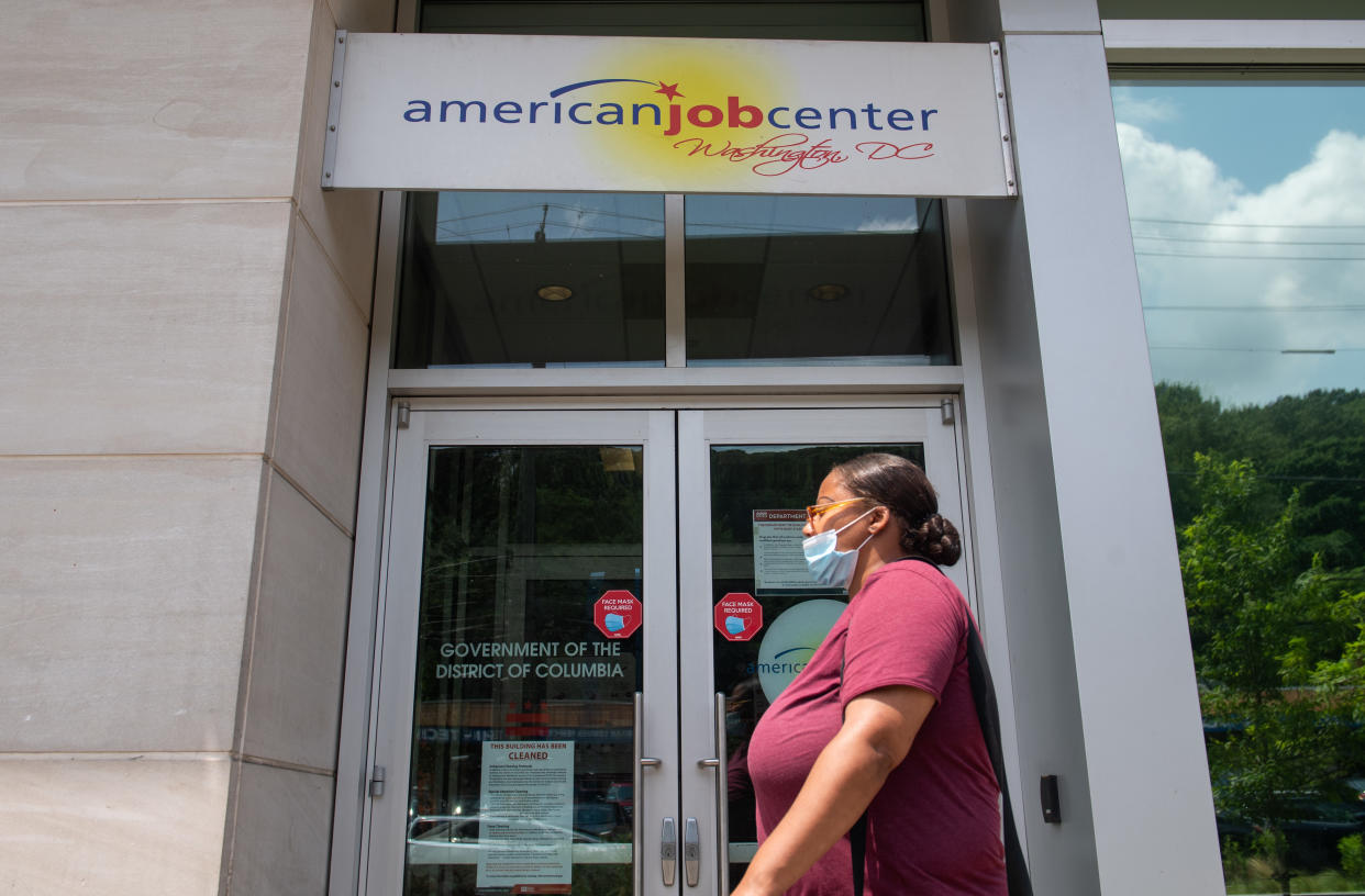 A woman walks past the the DC Department of Employment Services American Job Center, which assists in finding employment for out of work DC residents, in Washington, DC, July 16, 2020. - Americans worry as unemployment benefits are due to end soon. (Photo by SAUL LOEB / AFP) (Photo by SAUL LOEB/AFP via Getty Images)