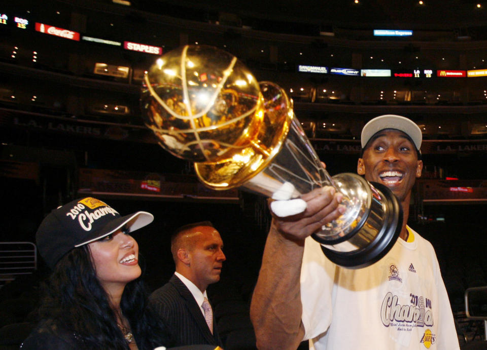 Los Angeles Lakers Kobe Bryant holds the NBA MVP trophy as he walks with his wife Vanessa after defeating the Boston Celtics to win Game 7 of the 2010 NBA Finals basketball series in Los Angeles, California, June 17, 2010. REUTERS/Lucy Nicholson (UNITED STATES - Tags: SPORT BASKETBALL)