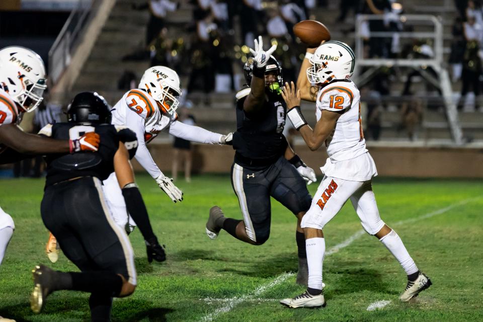 Eastside Rams quarterback Adrian Curtis (12) throws under pressure from Buchholz Bobcats defensive end Kendall Jackson (8) during the first half at Citizens Field in Gainesville, FL on Friday, September 8, 2023. [Matt Pendleton/Gainesville Sun]