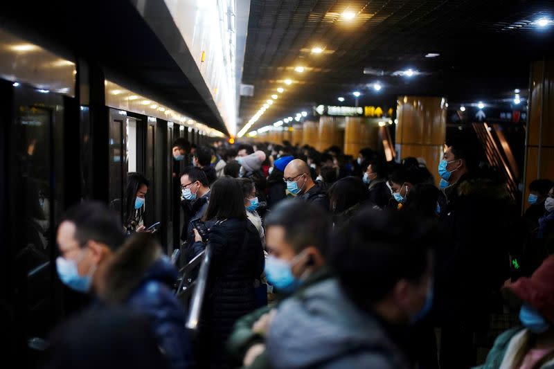 People wearing face masks are seen at a subway station following the coronavirus disease (COVID-19) outbreak, in Shanghai