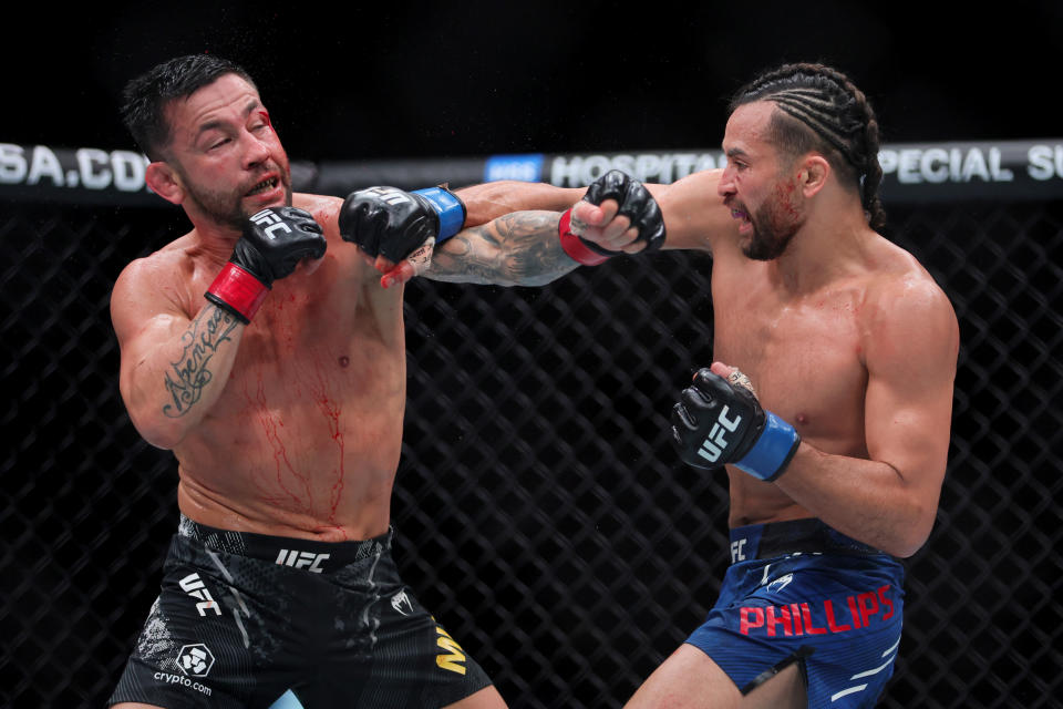 Mar 9, 2024; Miami, Florida, USA; Kyler Phillips (blue gloves) fights Pedro Munhoz (red gloves) during UFC 299 at Kayesa Center. Mandatory Credit: Sam Navarro-USA TODAY Sports