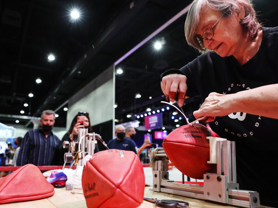 Lacer Barbara Gray laces a football at the Wilson football workshop in the Super Bowl Experience, the NFL's 'interactive football theme park', ahead of Super Bowl LVI.