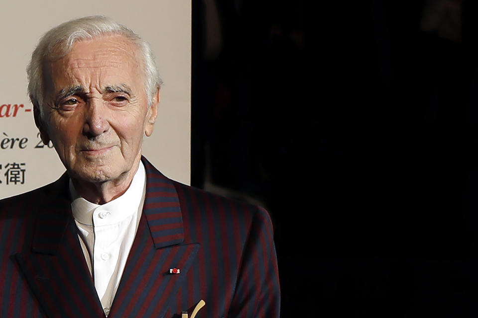 FILE - In this Oct.20, 2017 French singer Charles Aznavour poses for photographers as he arrives to attend the 9th Lumiere festival Award ceremony, in Lyon, central France, Friday. Charles Aznavour, the French crooner and actor whose performing career spanned eight decades, has died. He was 94. (AP Photo/Laurent Cipriani, File)