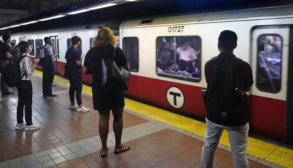 Commuters wait as a train full of passengers arrives at the South Station Red Line subway stop, Wednesday, July 13, 2022, in Boston. Boston's public transit system is a mess, harried commuters and officials are increasingly looking to a Chinese-owned subway car manufacturer to account for some of the troubles. There have been fatal accidents, subway car collisions, malfunctioning elevators, and trains running on weekend schedules during rush hour. (AP Photo/Charles Krupa)