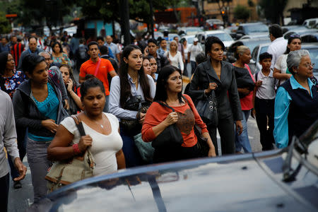 People walk on the street during a blackout in Caracas, Venezuela March 7, 2019. REUTERS/Carlos Garcia Rawlins