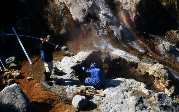 Alexander Belousov lowers a video camera into a geyser in Kamchatka.