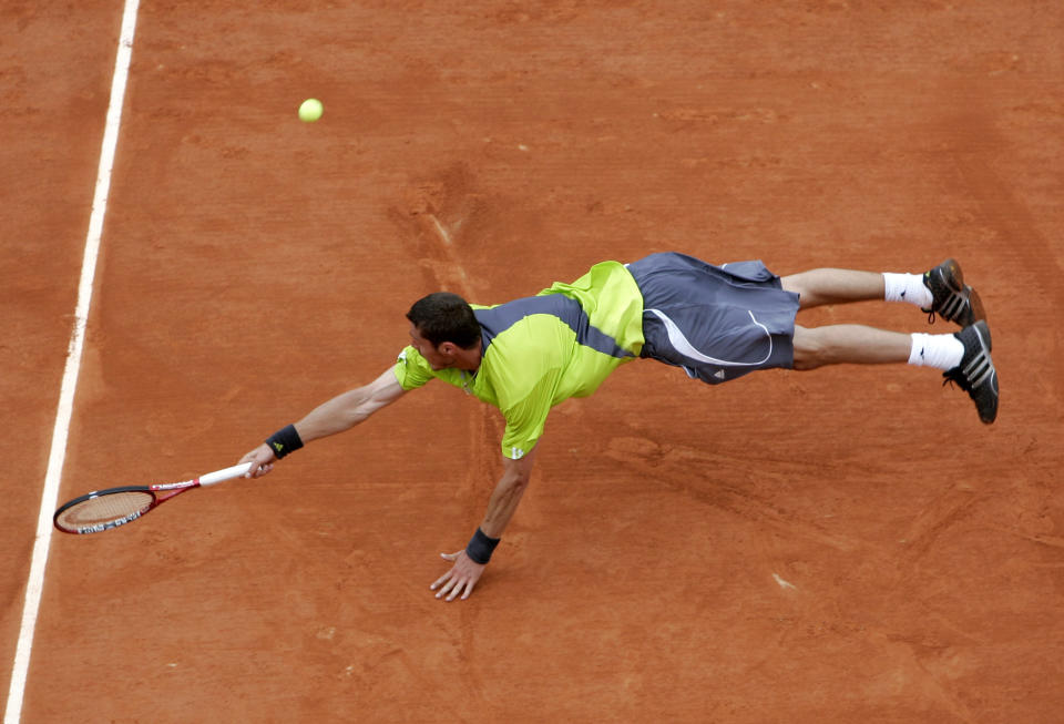 FILE - In this May 30, 2007, file photo, Russia's Marat Safin reaches for the ball as he plays Serbia's Janko Tipsarevic in their second round match of the French Open tennis tournament at Roland Garros stadium in Paris. (AP Photo/Lionel Cironneau, File)