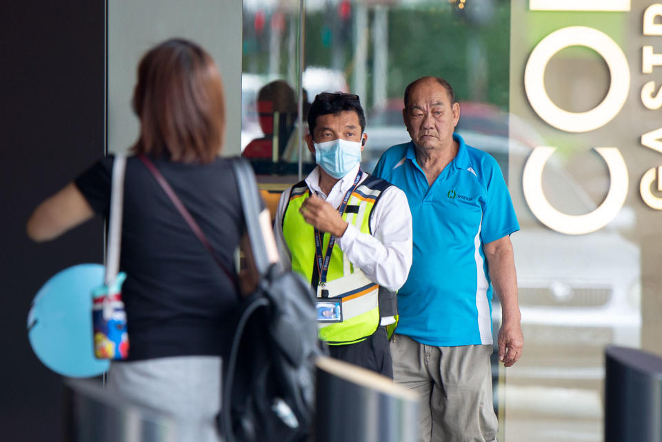 A security guard wearing a face mask standing outside the Funan Mall. (PHOTO: Dhany Osman / Yahoo News Singapore)