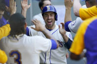 Seattle Mariners' Tom Murphy reacts in the dugout after he scored on an RBI-double hit by Mitch Haniger during the seventh inning of a baseball game against the Houston Astros, Sunday, April 18, 2021, in Seattle. (AP Photo/Ted S. Warren)