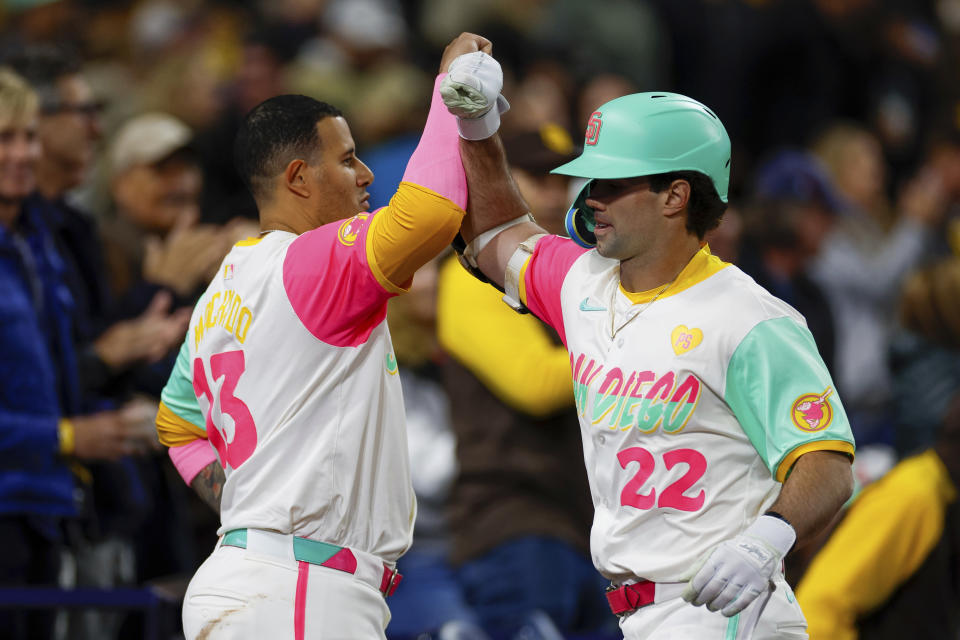 San Diego Padres' Graham Pauley, right, celebrates with Manny Machado after hitting a two-run home run during the seventh inning of a baseball game against the Philadelphia Phillies, Friday, April 26, 2024, in San Diego. (AP Photo/Brandon Sloter)