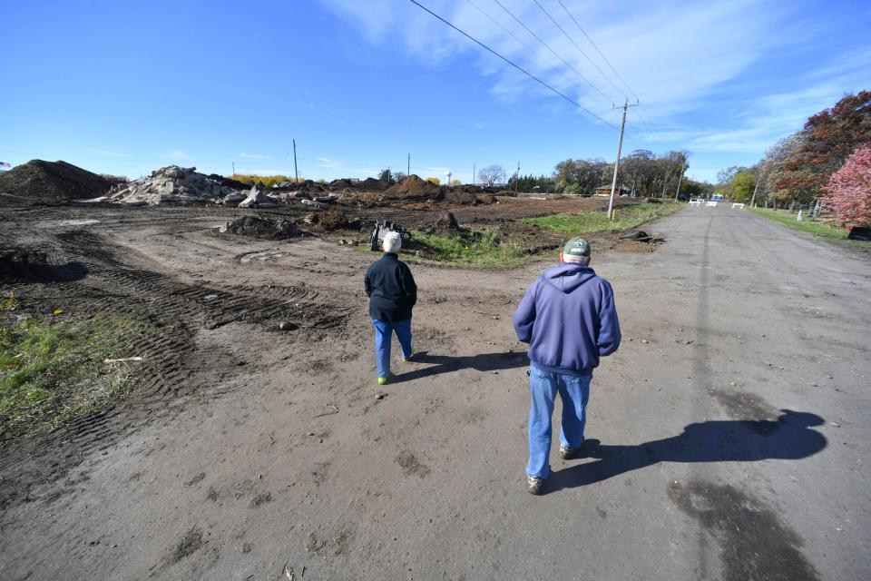 Jim and Diane Braegelman walk through their neighborhood on River Oaks Lane Tuesday, Oct. 26, 2021, in Sartell. Several homes and many trees have been removed in the area for development. 