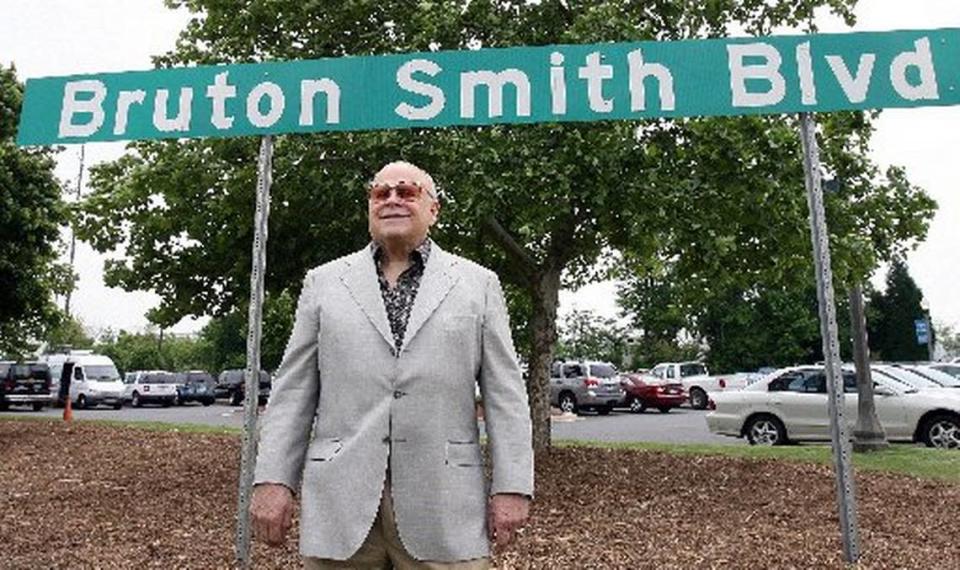 NASCAR track owner Bruton Smith died Wednesday at age 95. Here he poses in front of one of the Bruton Smith Boulevard road signs, which leads to Charlotte Motor Speedway in Concord.
