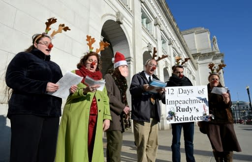 Trump supporters -- like these singing Christmas carols in Washington on December 18, 2019 -- decry the "partisan" nature of the impeachment