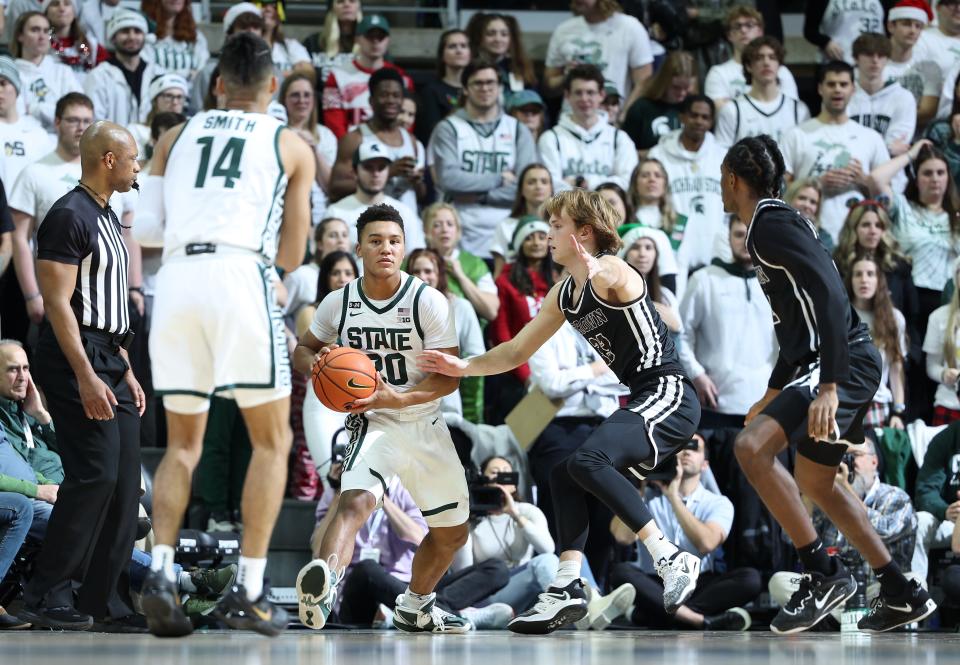 Nick Sanders #20 of the Michigan State Spartans looks to past the ball in the second half against the Brown Bears at Breslin Center on December 10, 2022 in East Lansing, Michigan. (Photo by Rey Del Rio/Getty Images)