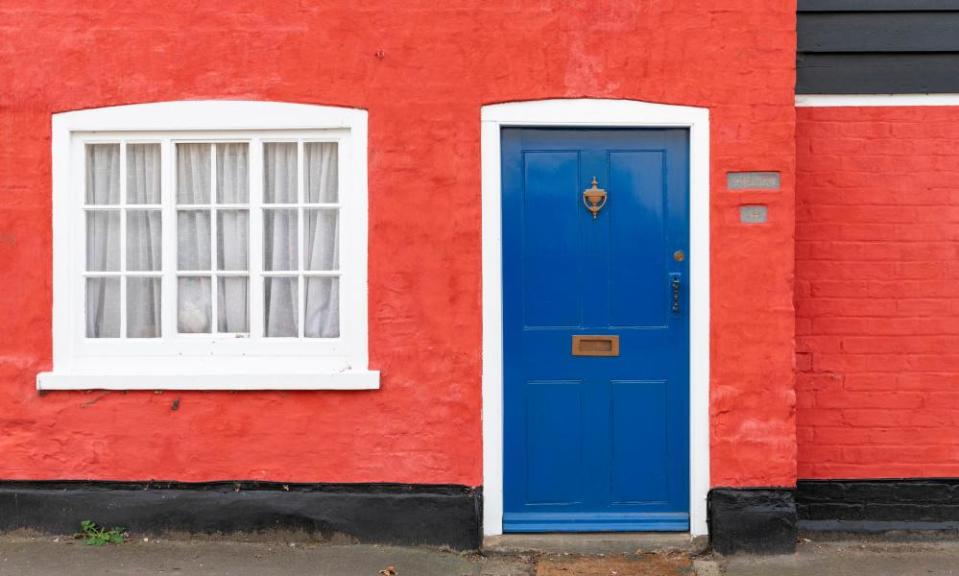 A brightly coloured cottage in a UK village