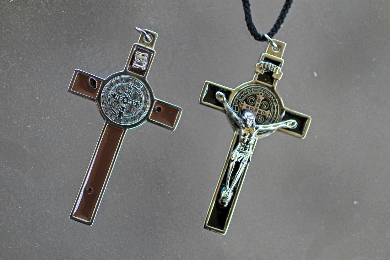 FILE - Father Mike Maginot used this crucifix, on right, to see if demons were present in Latoya Ammons. When he placed the crucifix on her, she reportedly convulsed, showing their presence. He gave her the Benedictine crucifix on the left, and reportedly the Christ figure disappeared.