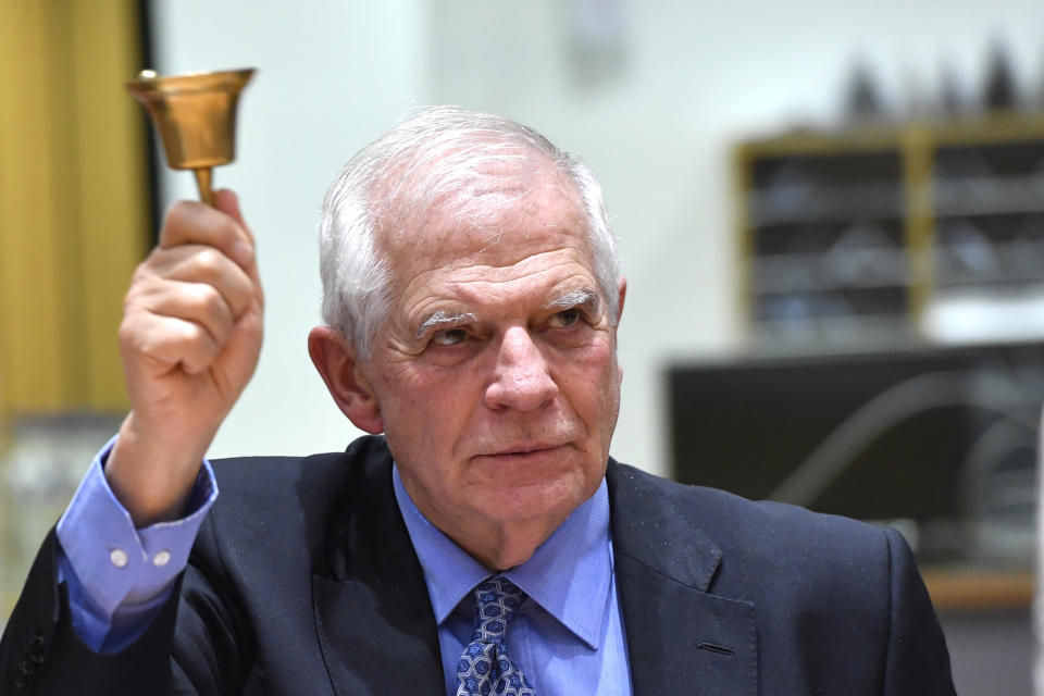 European Union foreign policy chief Josep Borrell rings a bell to signify the start of a meeting of EU foreign and defense ministers at the European Council building in Brussels on Monday, March 20, 2023. European Union foreign ministers on Monday will discuss the situation in Ukraine and Tunisia. (AP Photo/Geert Vanden Wijngaert)