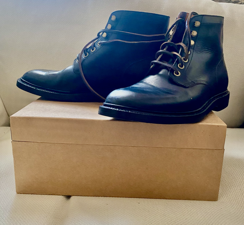 a pair of the grant stone diesel boots in black leather on top of the box