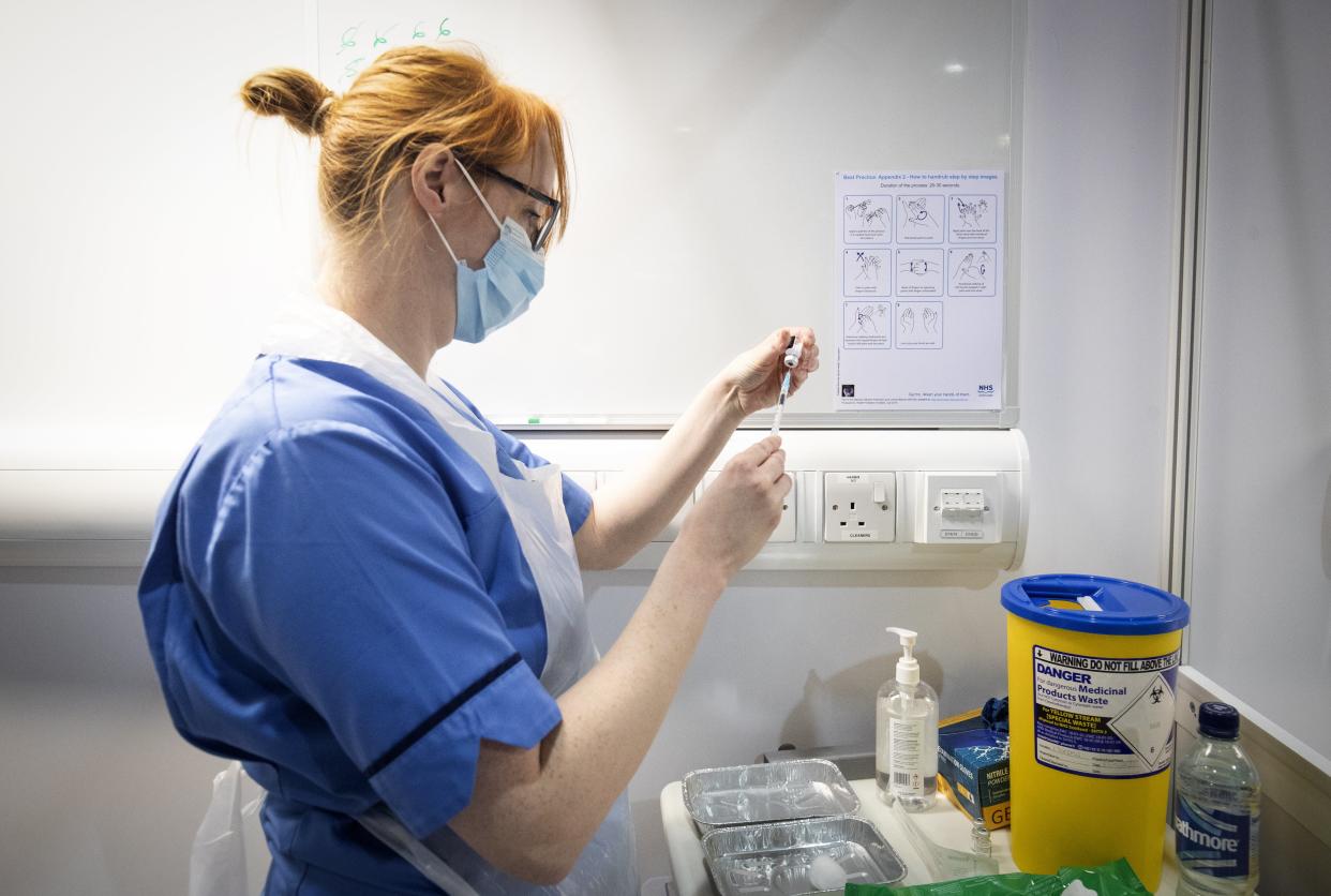 Nurse Eleanor Pinkerton prepares a coronavirus vaccine to be given to a health and care staff member at the NHS Louisa Jordan Hospital in Glasgow (PA Wire)