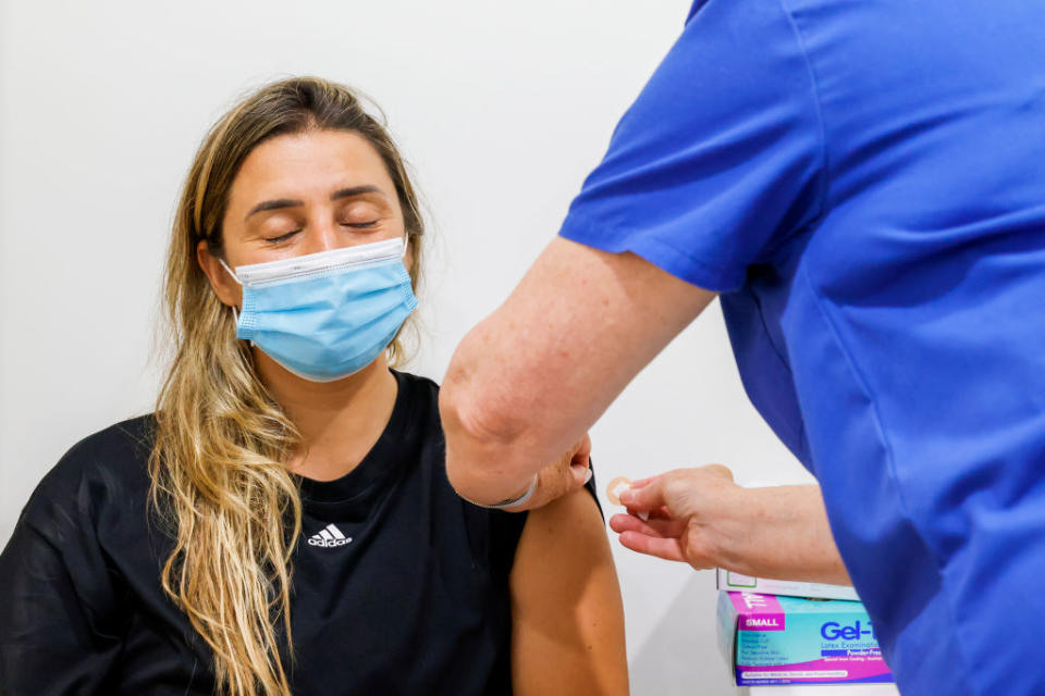 Eloa De Souza closes her eyes after receiving a COVID-19 vaccine at Sydney Road Family Medical Practice in Balgowlah in Sydney, Australia. 