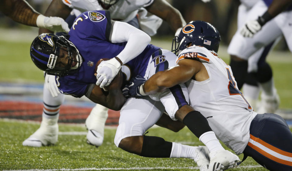 Chicago Bears linebacker Isaiah Irving, right, tackles Baltimore Ravens quarterback Robert Griffin III (3) during the first half of the Pro Football Hall of Fame NFL preseason game Thursday, Aug. 2, 2018, in Canton, Ohio. (AP Photo/Ron Schwane)