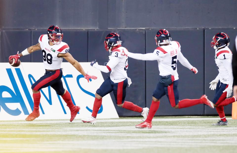 Montreal Alouettes defensive lineman Jamal Davis II (99) celebrates with teammates after recovering a fumble for a touchdown during the first quarter of a CFL game at IG Field, Nov. 6, 2021, in Winnipeg.