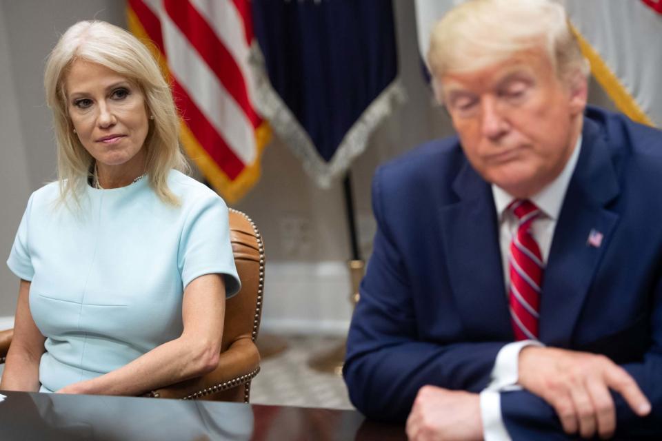 US President Donald Trump sits alongside Kellyanne Conway (AFP via Getty Images)