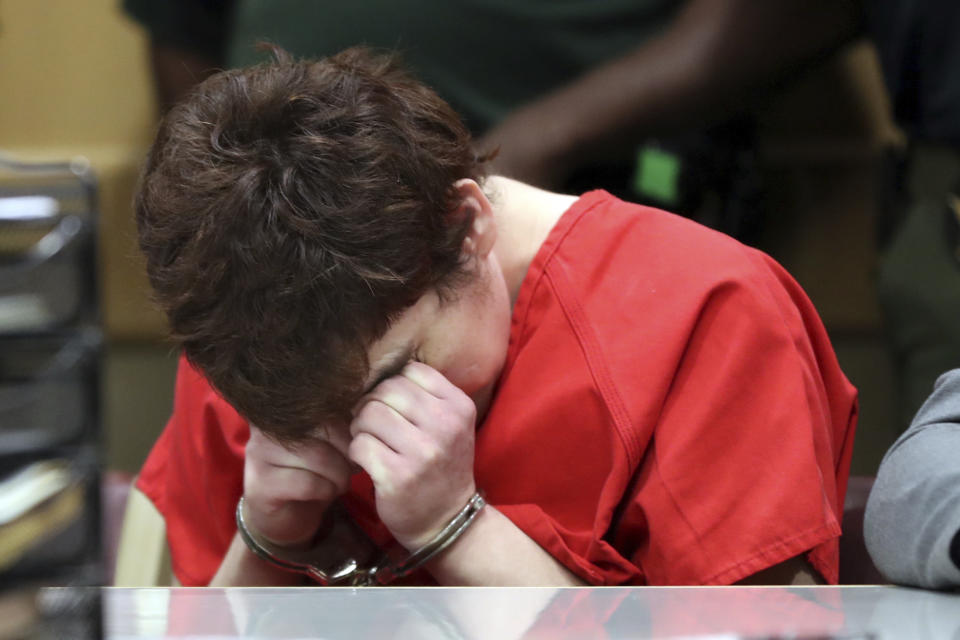 School shooting suspect Nikolas Cruz rubs his eyes as he sits down at the defense table during a hearing at the Broward Courthouse in Fort Lauderdale, Fla., Tuesday, May 28, 2019. Cruz, who faces the death penalty if convicted, is accused of killing 17 and wounding 17 in the February 2018 mass shooting at Marjory Stoneman Douglas High School in Parkland, Fla. (Amy Beth Bennett/South Florida Sun Sentinel via AP, Pool)