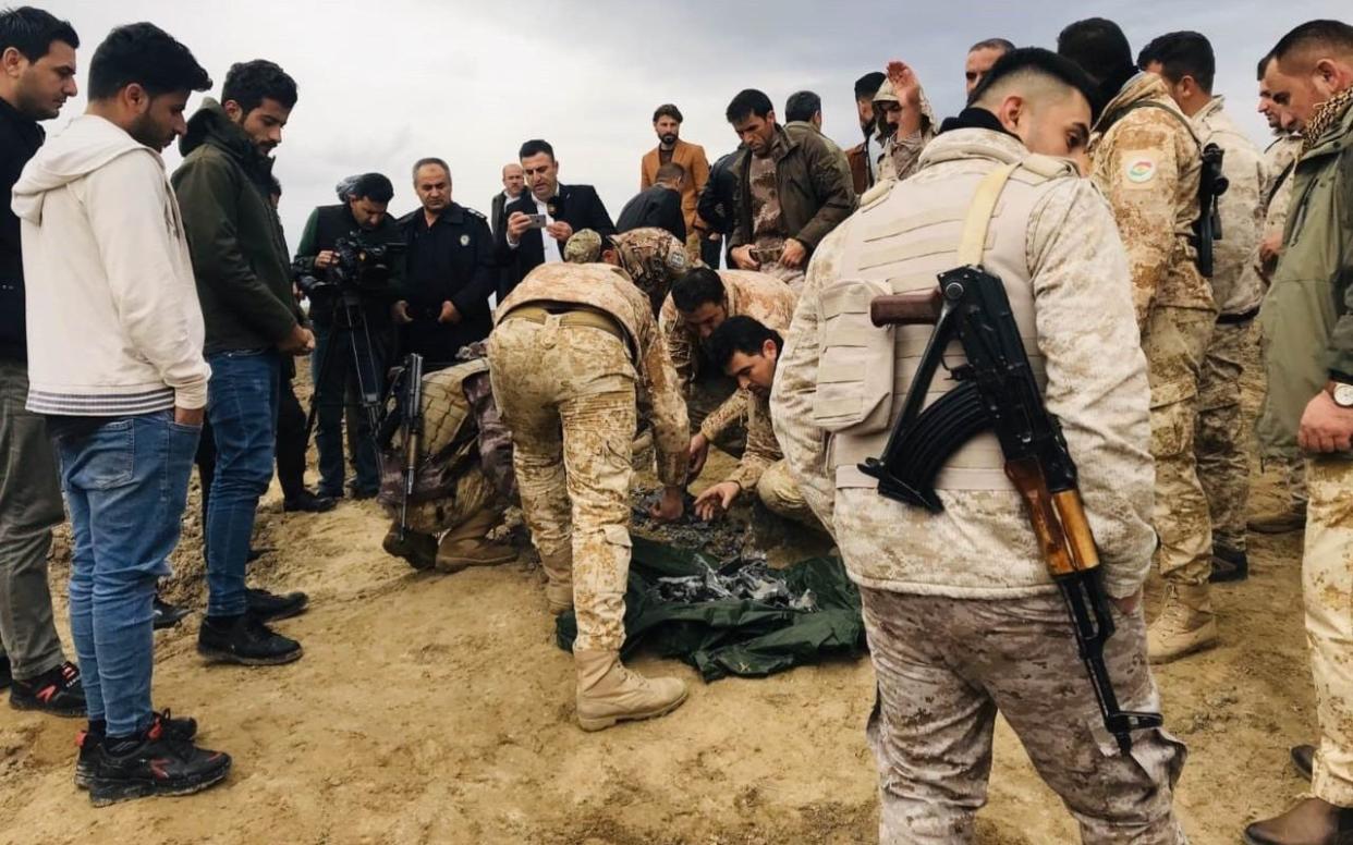  Iraqi security forces find and collect the pieces of missiles as they gather to inspect the site after Iran's Islamic Revolutionary Guard Corps (IRGC) targeted Ain al-Asad airbase in Iraq, a facility jointly operated by U.S. and Iraqi forces, at Bardarash district of Erbil in Iraq - Anadolu