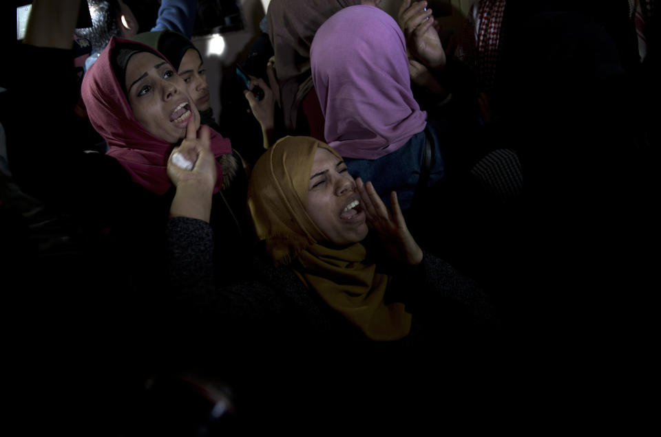 Relatives of Palestinian woman, Amal al-Taramsi, 43, who was killed by Israeli troops during Friday's protest at the Gaza Strip's border with Israel, mourn during her funeral in Gaza City, Saturday, Jan. 12, 2019. (AP Photo/Khalil Hamra)