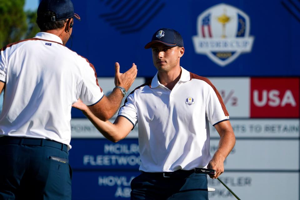 Team Europe's Ludvig Aberg, right, celebrates with vice captain Francesco Molinari after a putt on the sixth green during day two foursomes matches in the 44th Ryder Cup. The event is taking place at Marco Simone Golf and Country Club near Rome, Italy.