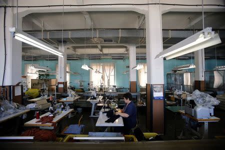 An employee of clothing retailer Arena Modna Kuca sews in the company's factory in the Adriatic town of Pula July 1, 2014. REUTERS/Antonio Bronic