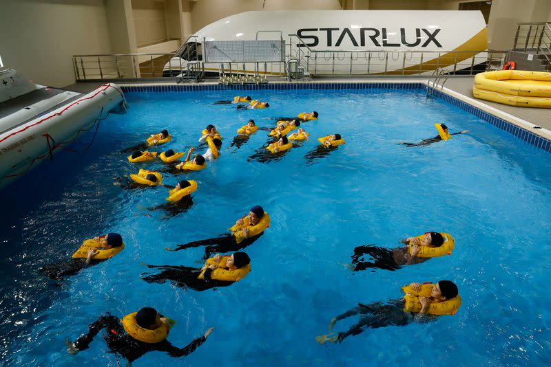 Starlux flight attendants receive emergency landing and slide trainings in a pool at their center in Taoyuan