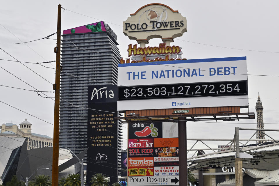 A billboard displaying the U.S. national debt is displayed along the Las Vegas Strip after all the casinos and non-essential businesses in the state were ordered to shut down due to the coronavirus Wednesday, March 18, 2020, in Las Vegas. For most people, the new coronavirus causes only mild or moderate symptoms, such as fever and cough. For some, especially older adults and people with existing health problems, it can cause more severe illness, including pneumonia. (AP Photo/David Becker)