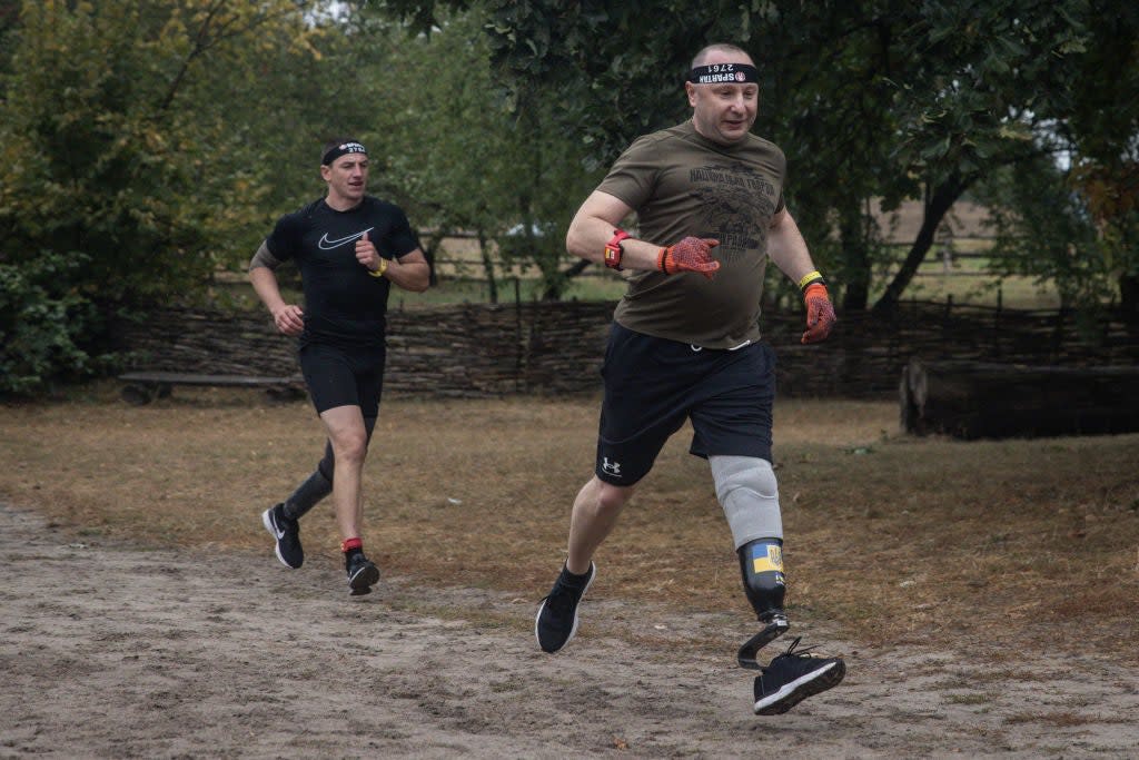 49 year-old amputee soldier Serhyi runs during a Spartan race in Kyiv. Serhyi lost his leg from mortar fire during fighting in Kreminna in 2022 (Getty Images)