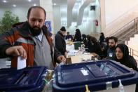 Man casts his vote during parliamentary elections at a polling station in Tehran