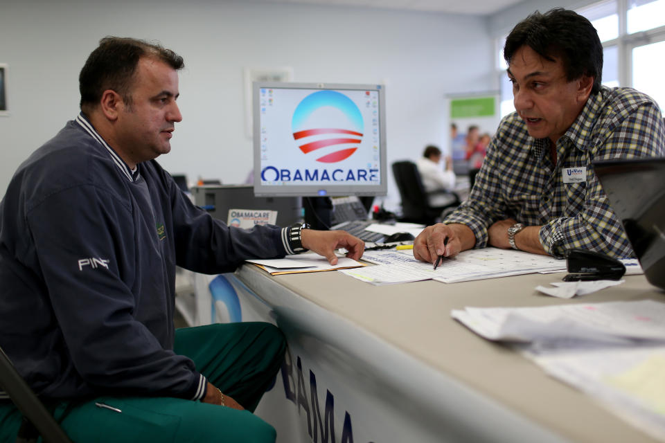 MIAMI, FL - FEBRUARY 05:  Ariel Fernandez (L) sits with Noel Nogues, an insurance  advisor with UniVista Insurance company, as he signs up for the Affordable Care Act, also known as Obamacare, before the February 15th deadline on February 5, 2015 in Miami, Florida. Numbers released by the government show that the Miami-Fort Lauderdale-West Palm Beach metropolitan area has signed up 637,514 consumers so far since open enrollment began on Nov. 15, which is more than twice as many as the next large metropolitan area, Atlanta, Georgia.  (Photo by Joe Raedle/Getty Images)