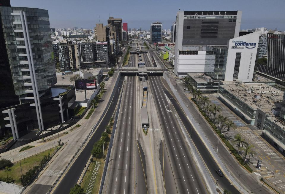 The "Via Rapida Libre" is empty in the San Isidro financial district of Lima, Peru, Tuesday, April 5, 2022. Peru’s President Pedro Castillo imposed a tight curfew on the capital and the country’s main port in response to sometimes violent protests over rising prices of fuel and food, requiring people in Lima and Callao to mostly stay in their homes all of Tuesday. (AP Photo/Martin Mejia)