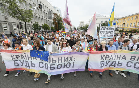 Participants carry a banner reading "Country of the free be yourself" during the Equality March, organized by the LGBT community, in Kiev, Ukraine June 17, 2018. REUTERS/Valentyn Ogirenko