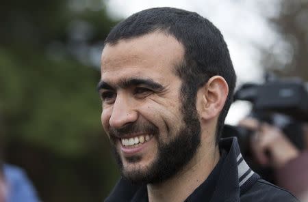 Omar Khadr smiles as he answers questions during a news conference after being released on bail in Edmonton, Alberta, May 7, 2015. REUTERS/Todd Korol