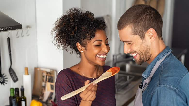 young couple tasting sauce