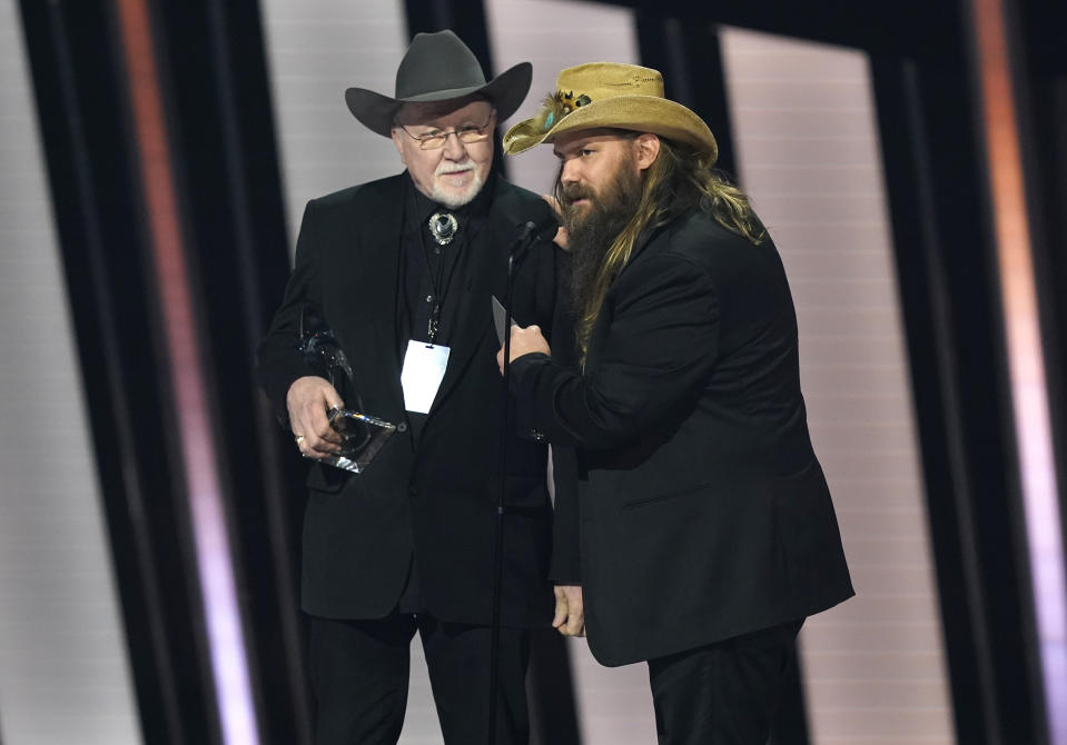 Mike Henderson, left, and Chris Stapleton accept the song of the year award for "Starting Over" at the 55th annual CMA Awards on Wednesday, Nov. 10, 2021, at the Bridgestone Arena in Nashville, Tenn. (AP Photo/Mark Humphrey)