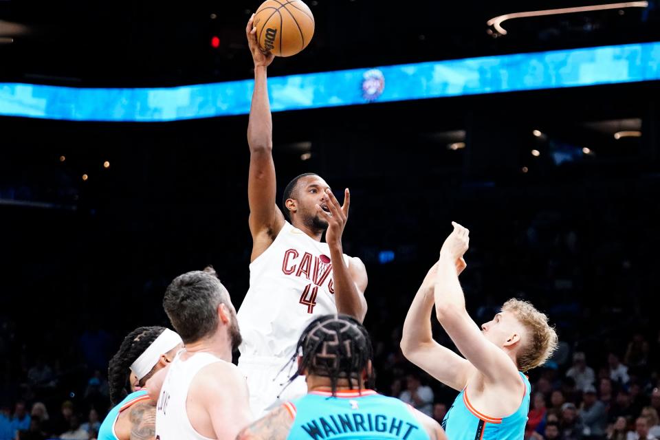 Cleveland Cavaliers' Evan Mobley (4) puts up a shot over Phoenix Suns' Jock Lansdale, right, during the first half of an NBA basketball game in Phoenix, Sunday, Jan. 8, 2023. (AP Photo/Darryl Webb)